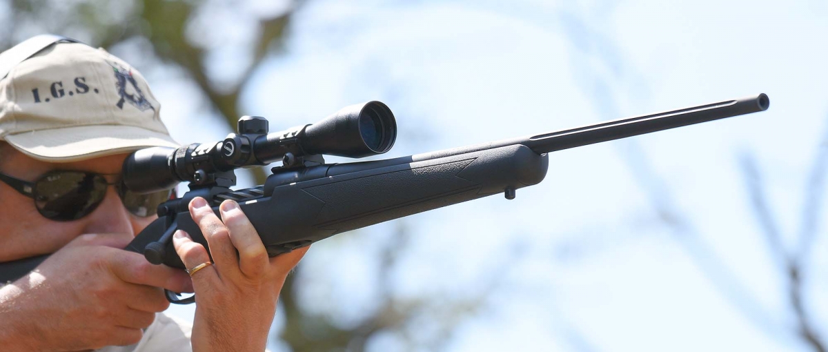 The rifle features a fluted barrel