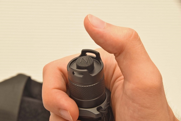 The on/off switch button on the flashlight back