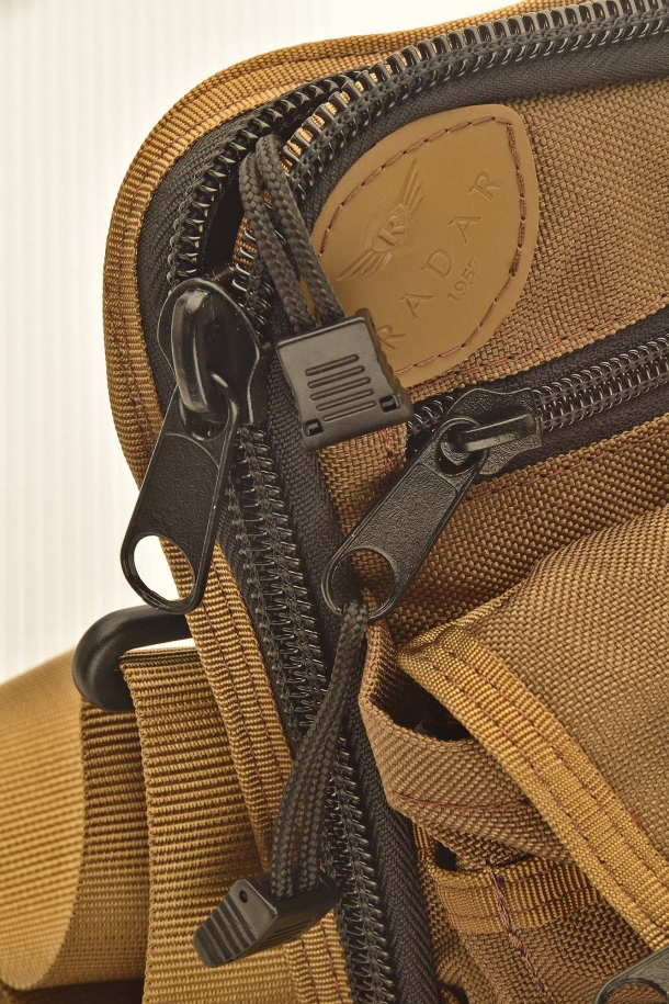 The Radar 1957 company logo is impressed on a leather patch sewn on the cordura