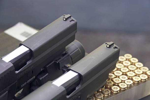 The iron sights feature white dots and are dovetailed to the slide