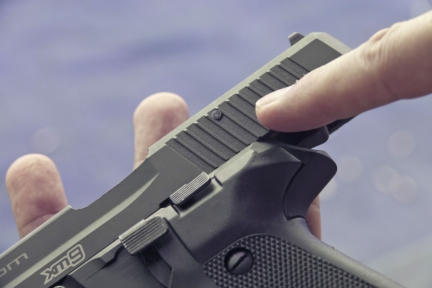 A close-up of the passing pin that keeps the breechblock in place within the slide assembly