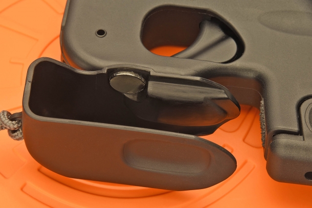 The trigger cover is pressure-released and wraps around the trigger guard