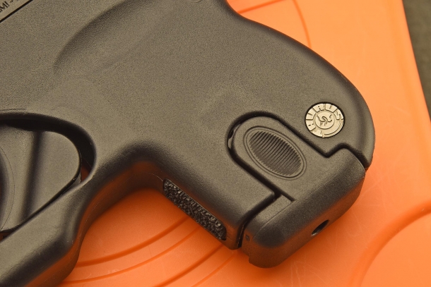 A close-up of the pinching surface to press on in order to release the magazine