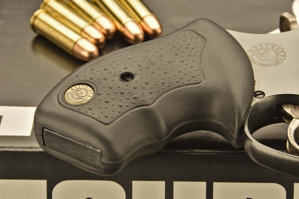 The rubber grip of the revolver