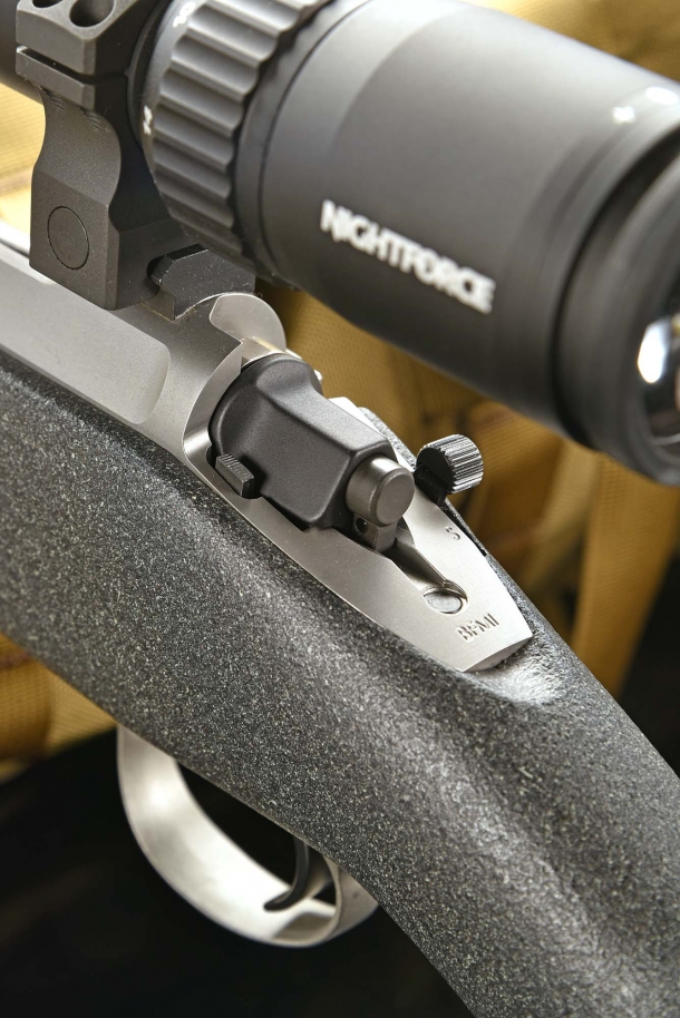The bolt release button is exactly on the opposite side, at the left of the bolt tail