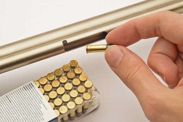 Cartridges are loaded one by one, via the loading window under the magazine tube