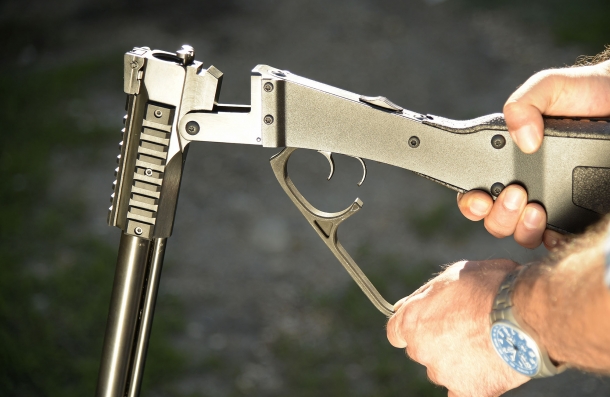 The gun breaks open by acting on the big lever protecting the triggers