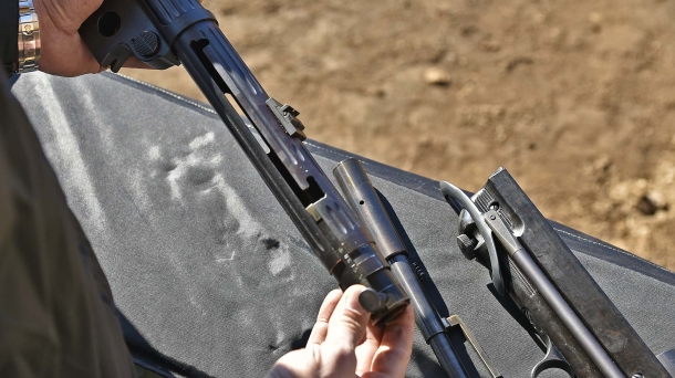 The components are separated; the return spring also dubs as a recoil buffer