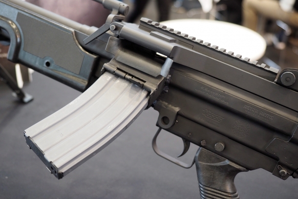 The MG556 only feeds through detacheable STANAG magazines