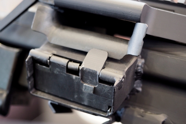 The belt-feeding port located over the magazine well is a dummy