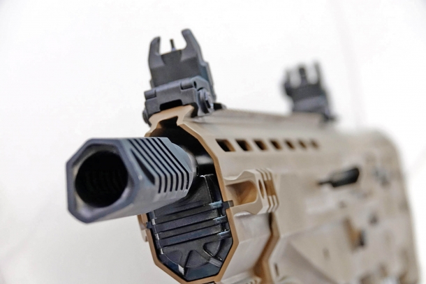 The massive muzzle device of the UNG-12 shotgun