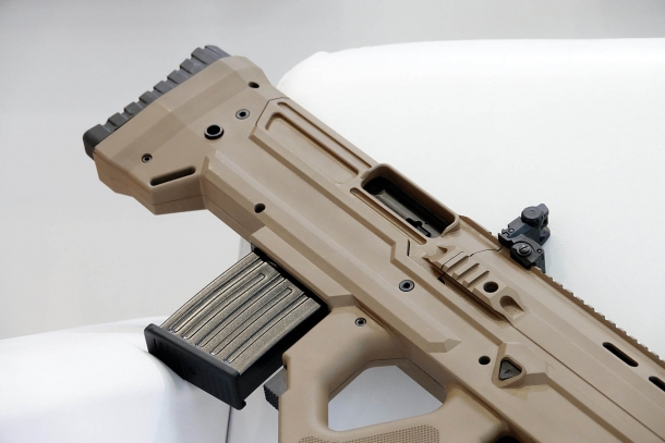 The ejection window is located on the right side of the upper receiver